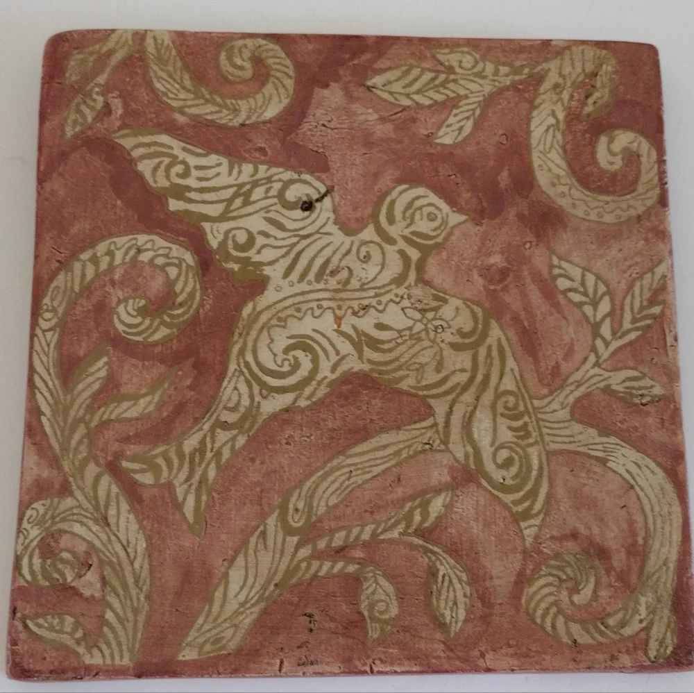 Kate McRostie hand-painted tile wall hanging with bird in bole